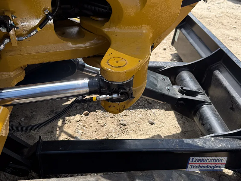 Tail line from ReliaMAX™ lubrication system greasing a cylinder pin on a CAT 305 Mini Excavator