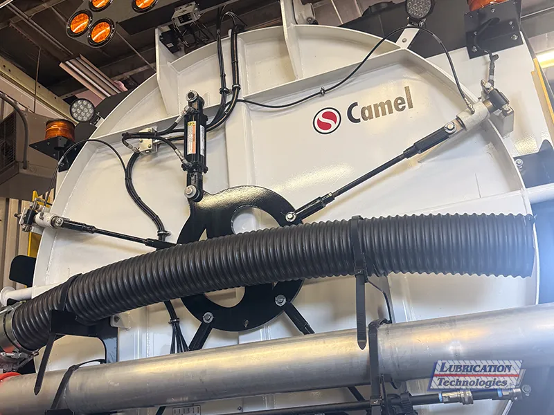 Rear hydraulic components and hose routing on vacuum tank.