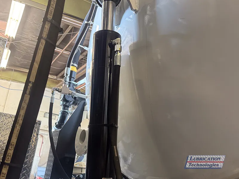 Grease line connected to hydraulic cylinder on Super Products Camel 1200 Vacuum Truck