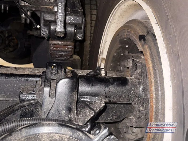 Lubricated S-cam brake and axle connection with grease fitting